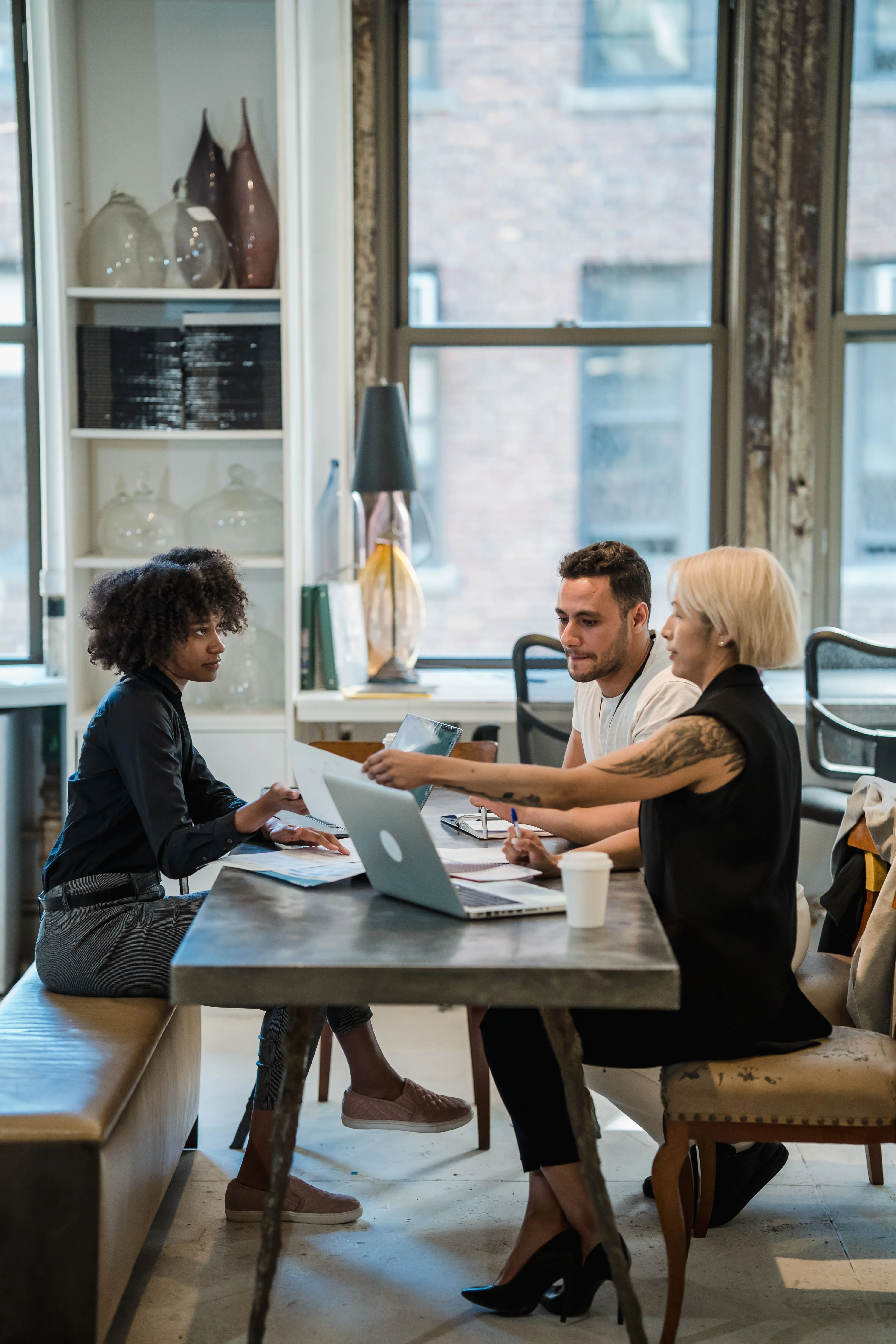Colleagues discussing options at a table, weighing the criteria a real buyer cares about