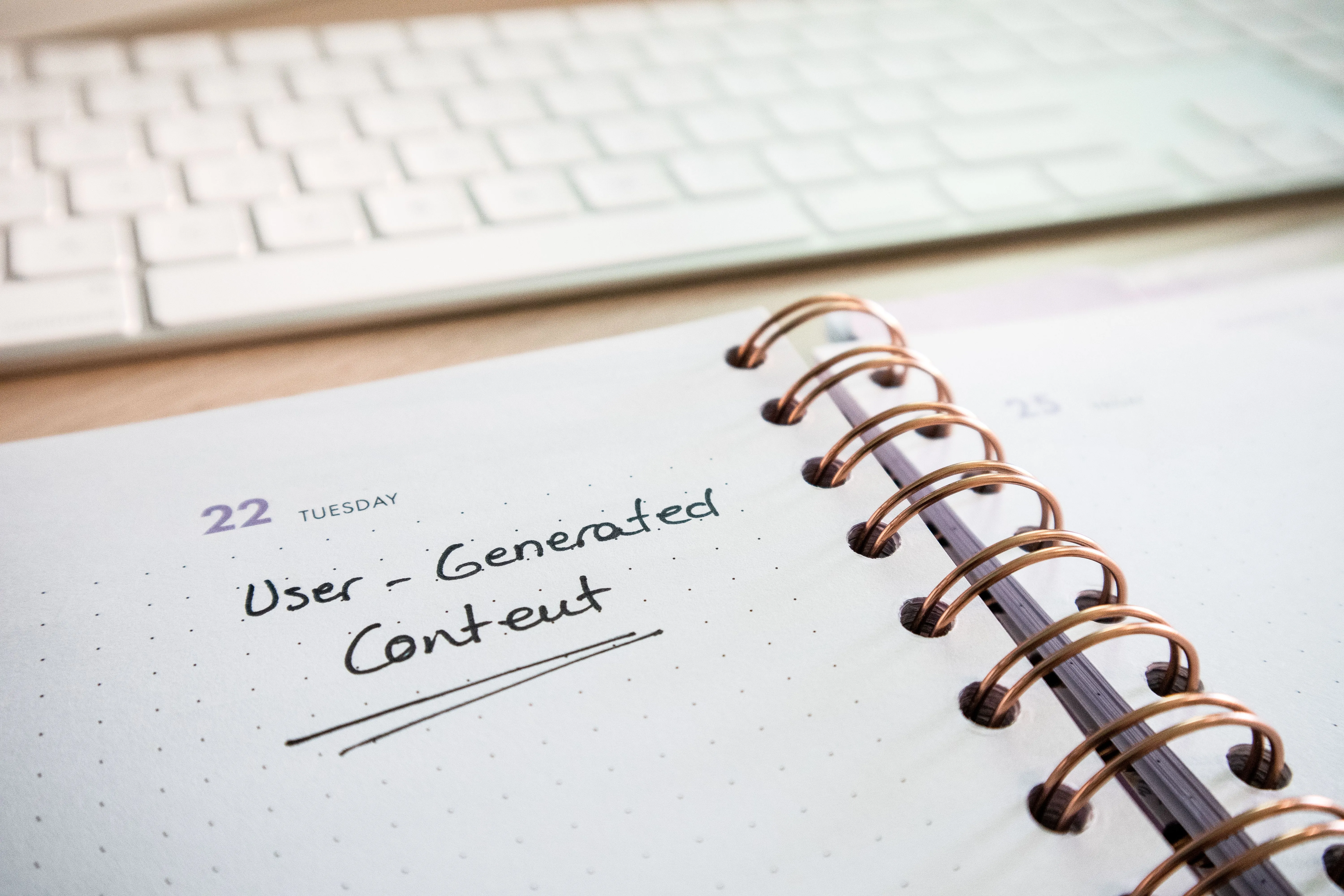 A notebook open beside a keyboard, where the boring part of content marketing actually happens