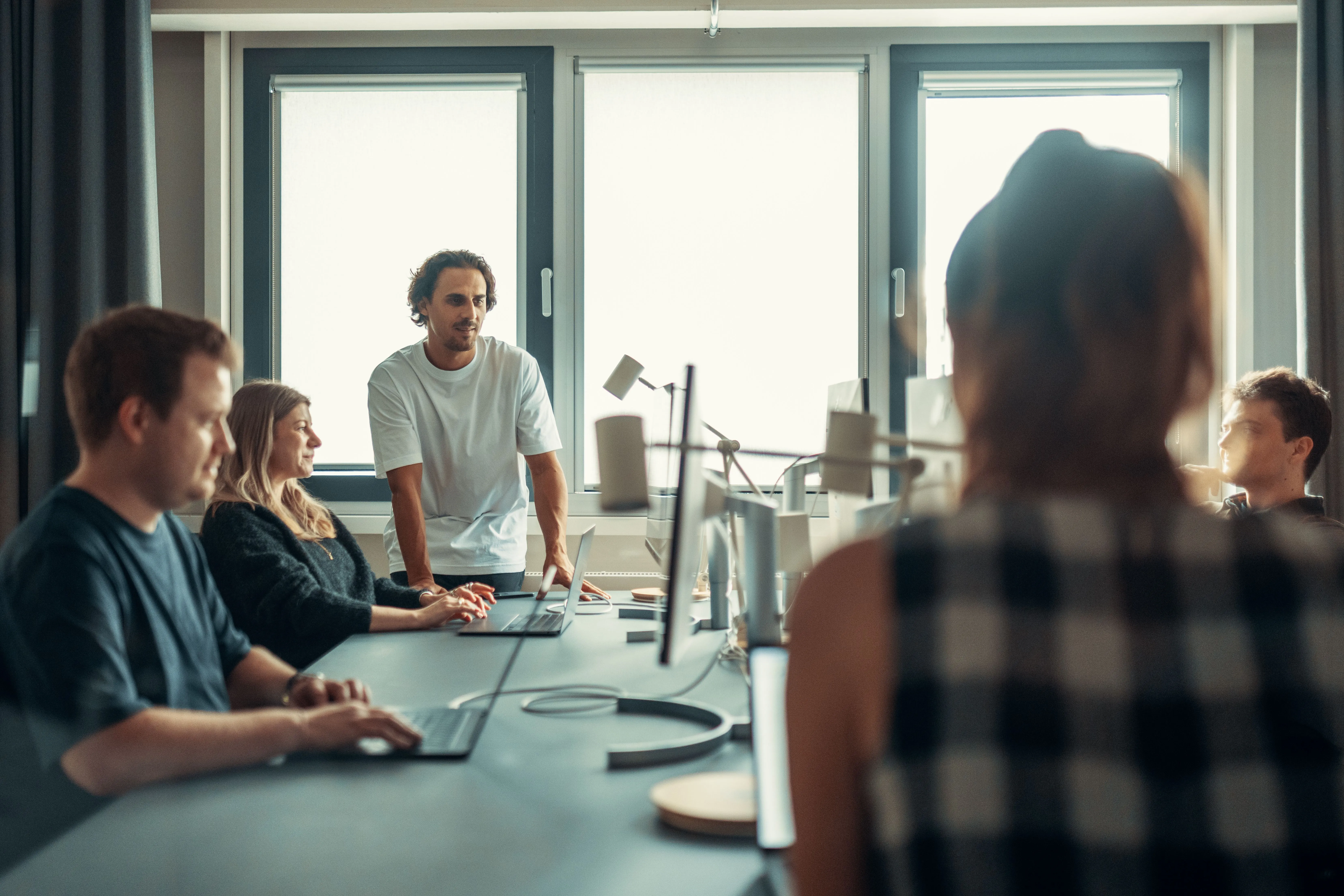 A collaborative team meeting in a modern office, moving quickly to shape a timely reaction