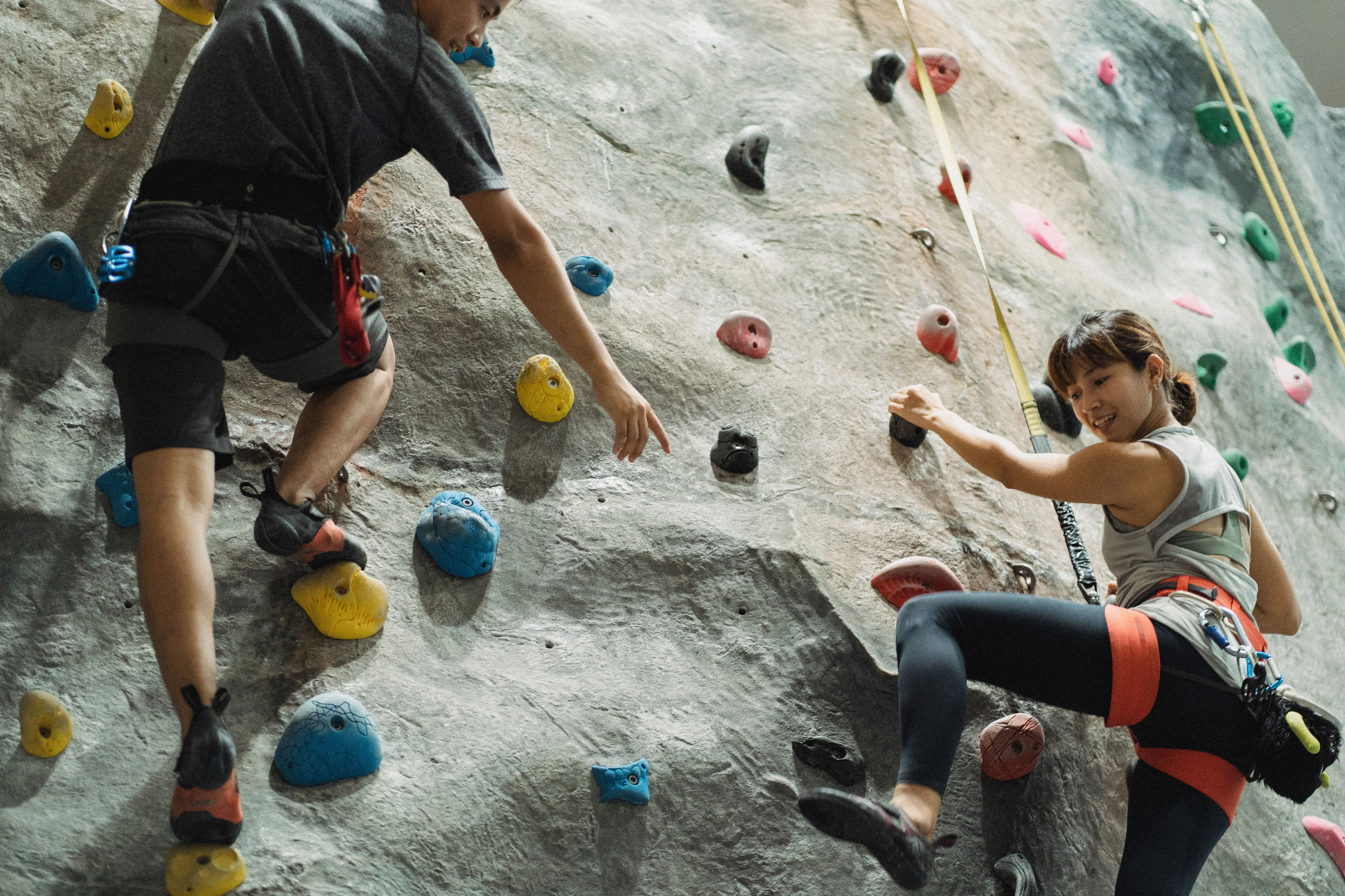 A coach working with a climber on the wall, the kind of session most gyms film and never explain