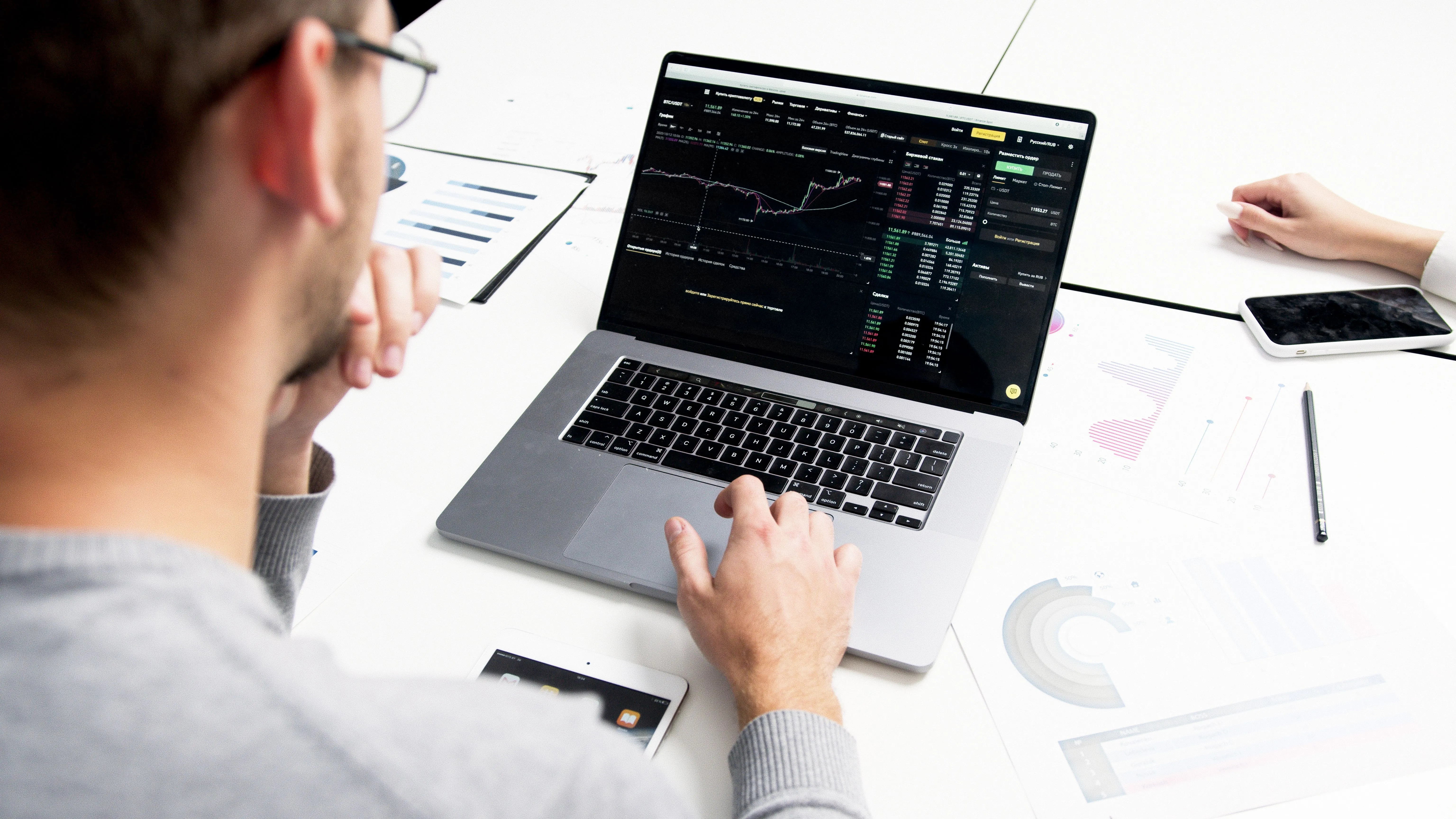 A person reviewing a chart on a laptop, tracking whether their name is gaining reach