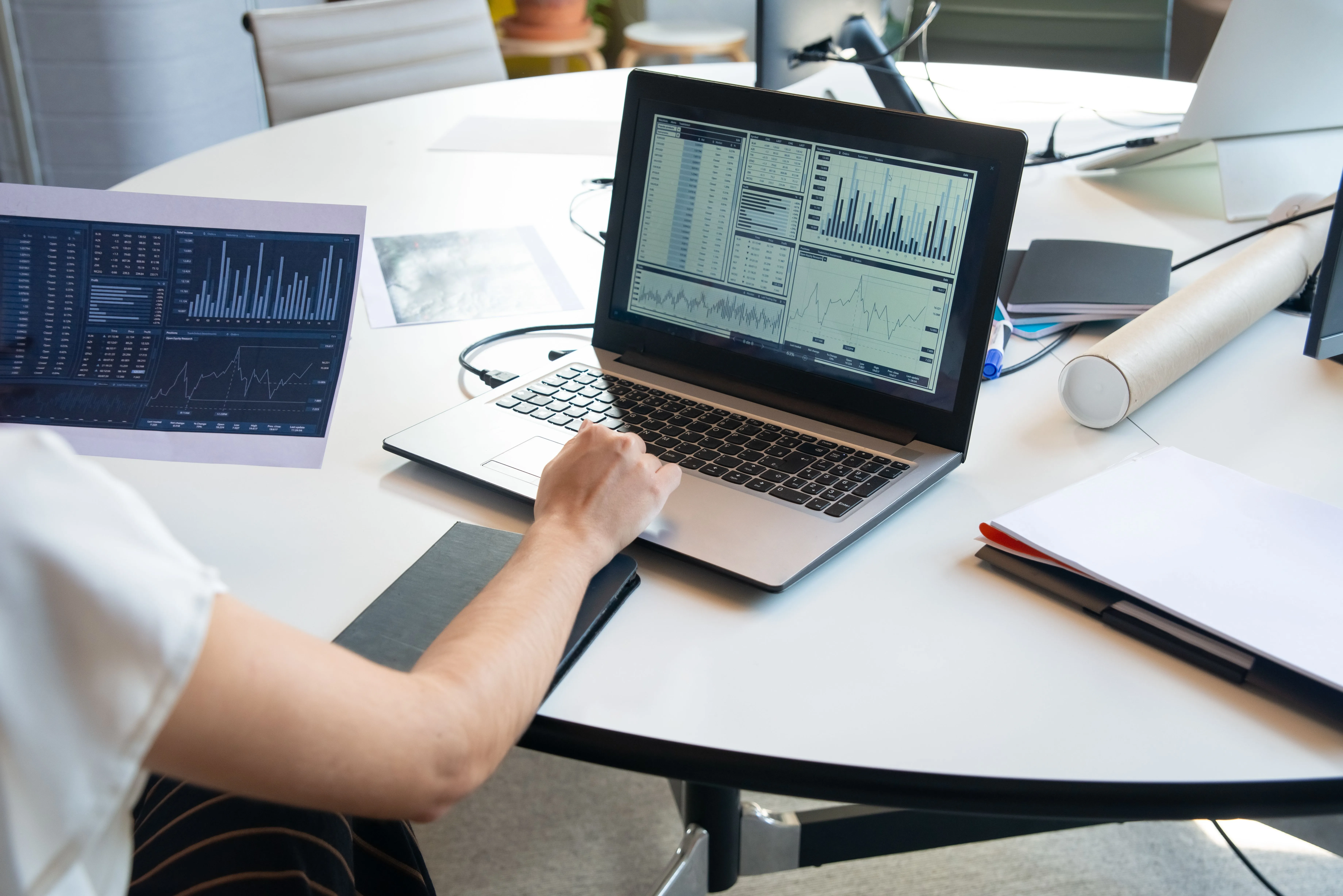 Notes and a laptop with charts on a desk, the planning behind a durable how-to guide