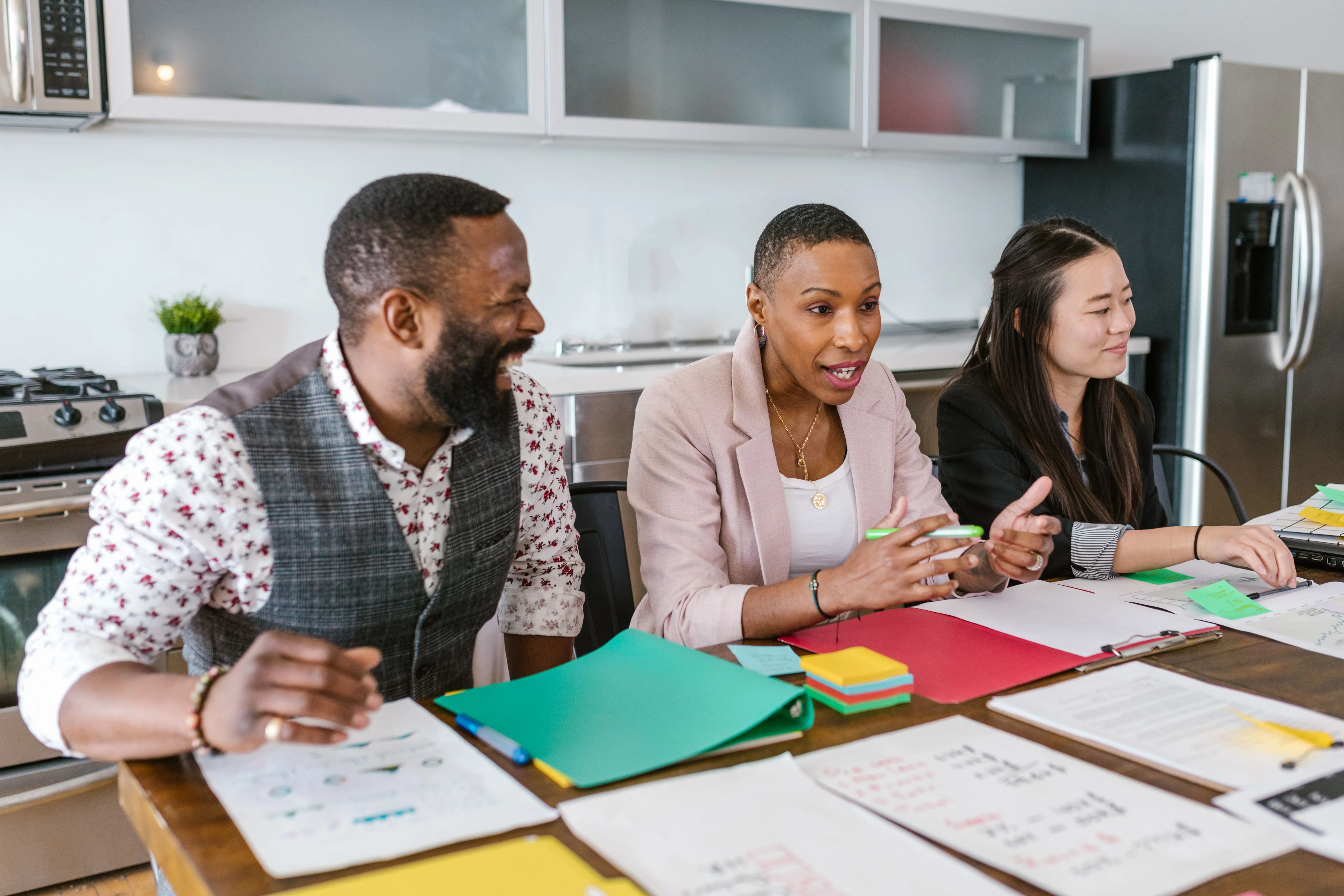 A team seated around a table evaluating a submission, the fast judgment every pitch must survive