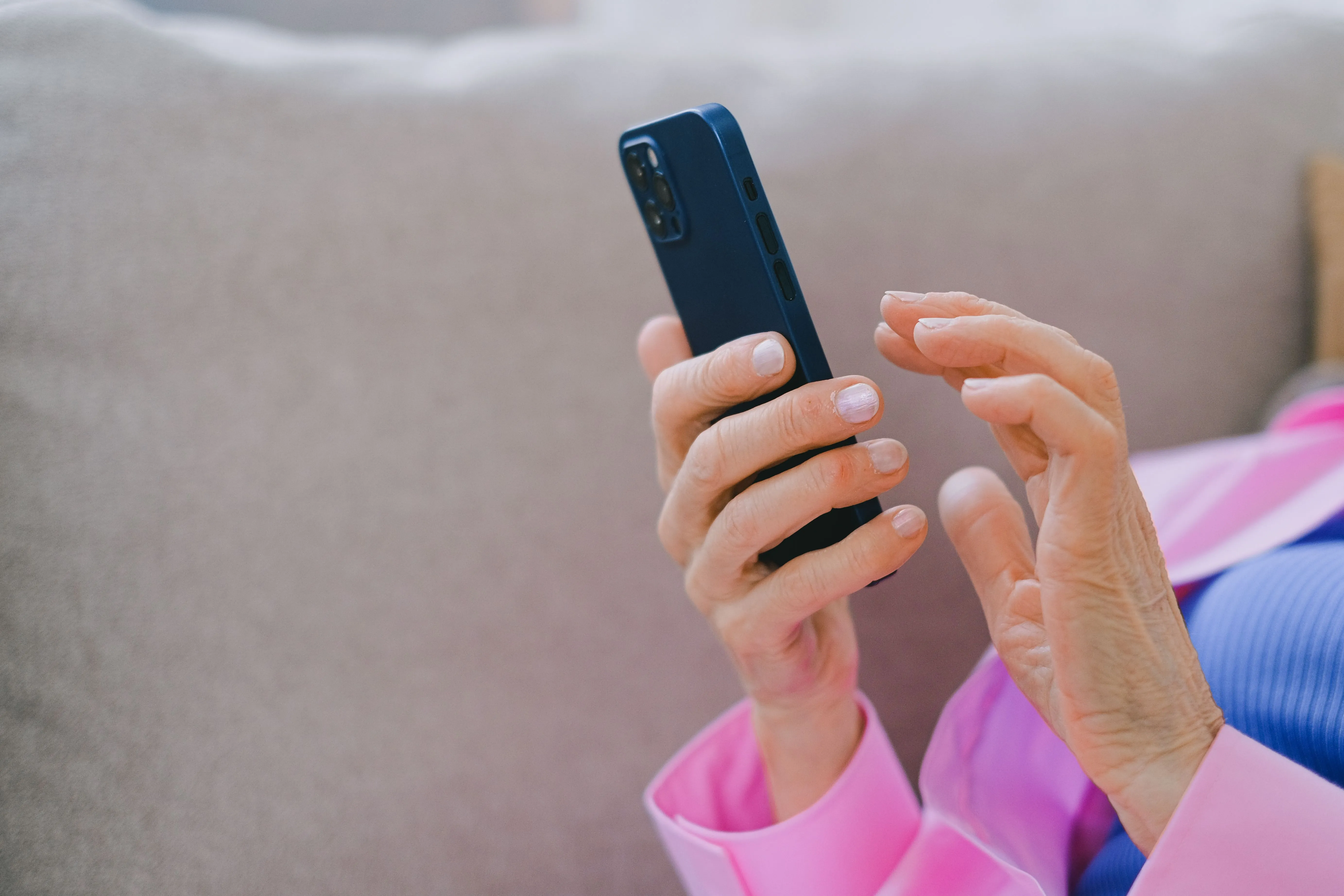 A close-up of hands typing a review on a smartphone