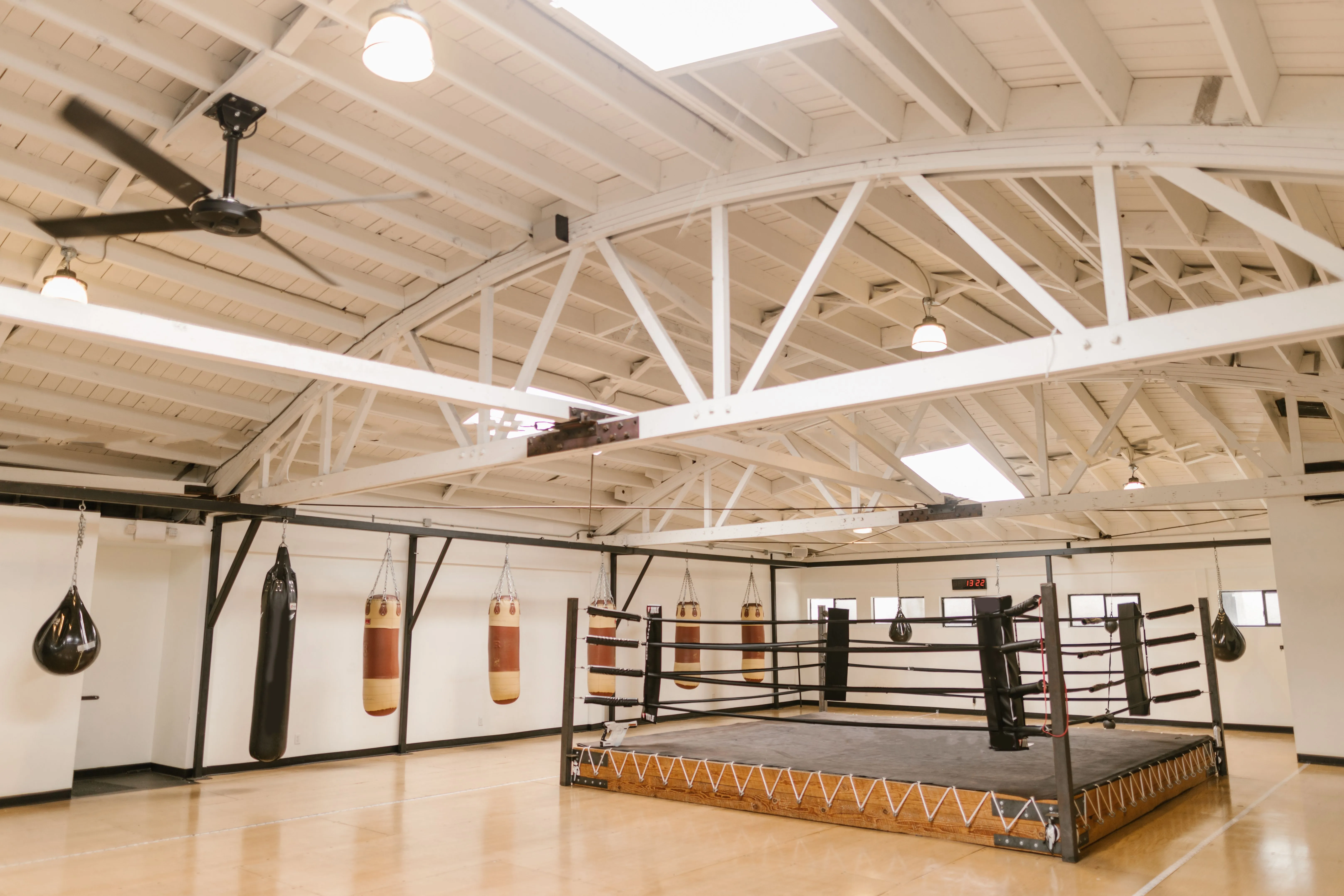A clean and empty boxing gym, the room a beginner is imagining before they ever see it