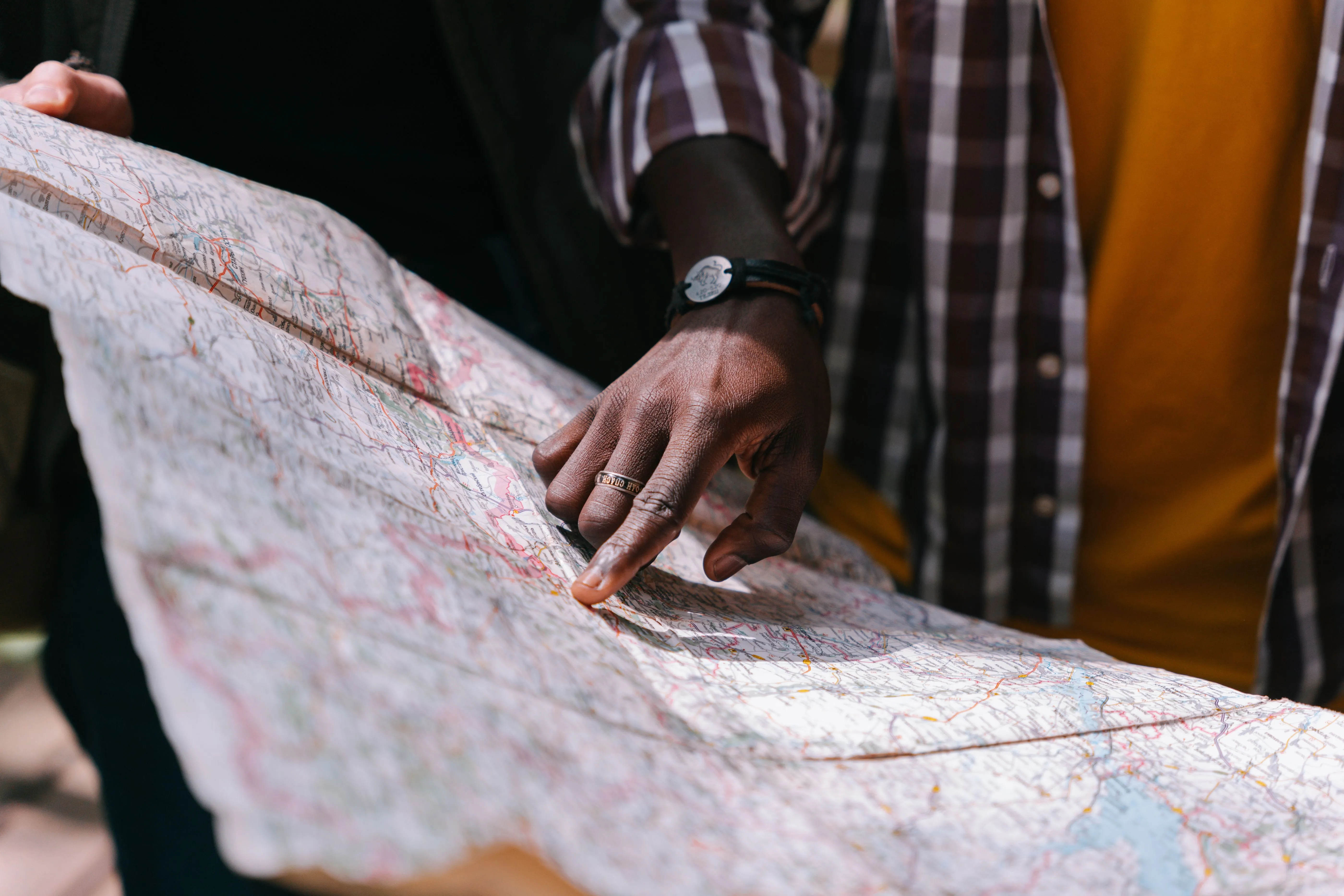 A person pointing at a location on a map, the moment intent turns into a specific recommendation