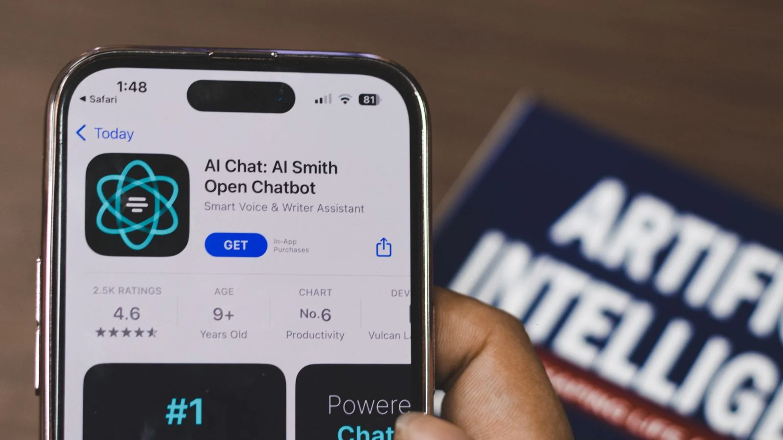 A hand holding a smartphone displaying an AI chatbot app.