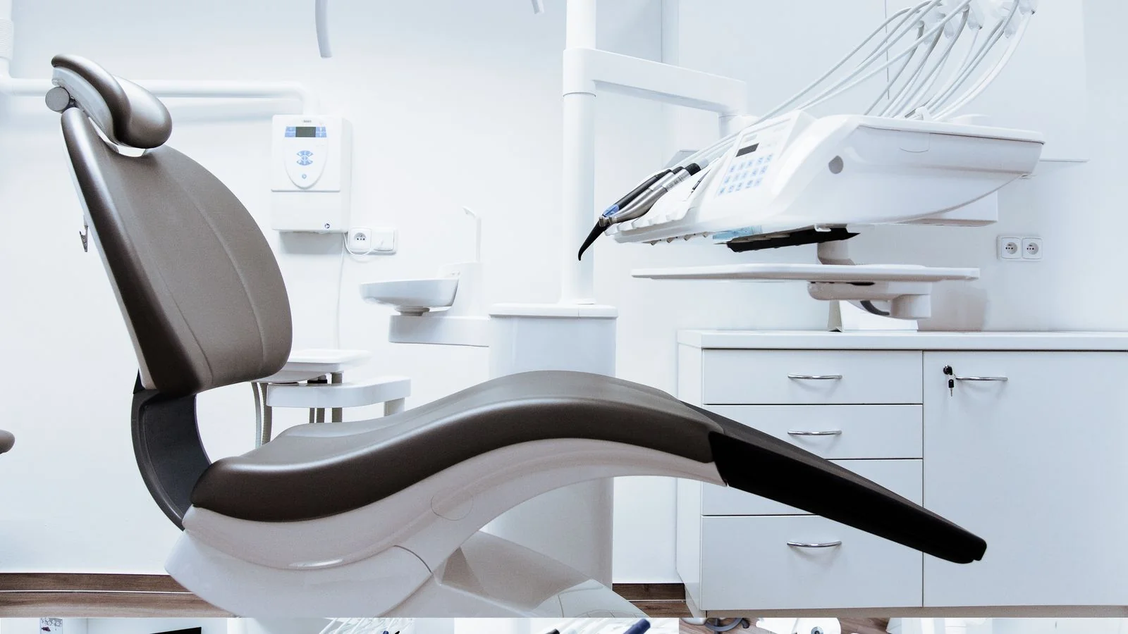Modern dental clinic interior with chair and equipment, the practice whose reputation an AI reconstructs from reviews and mentions