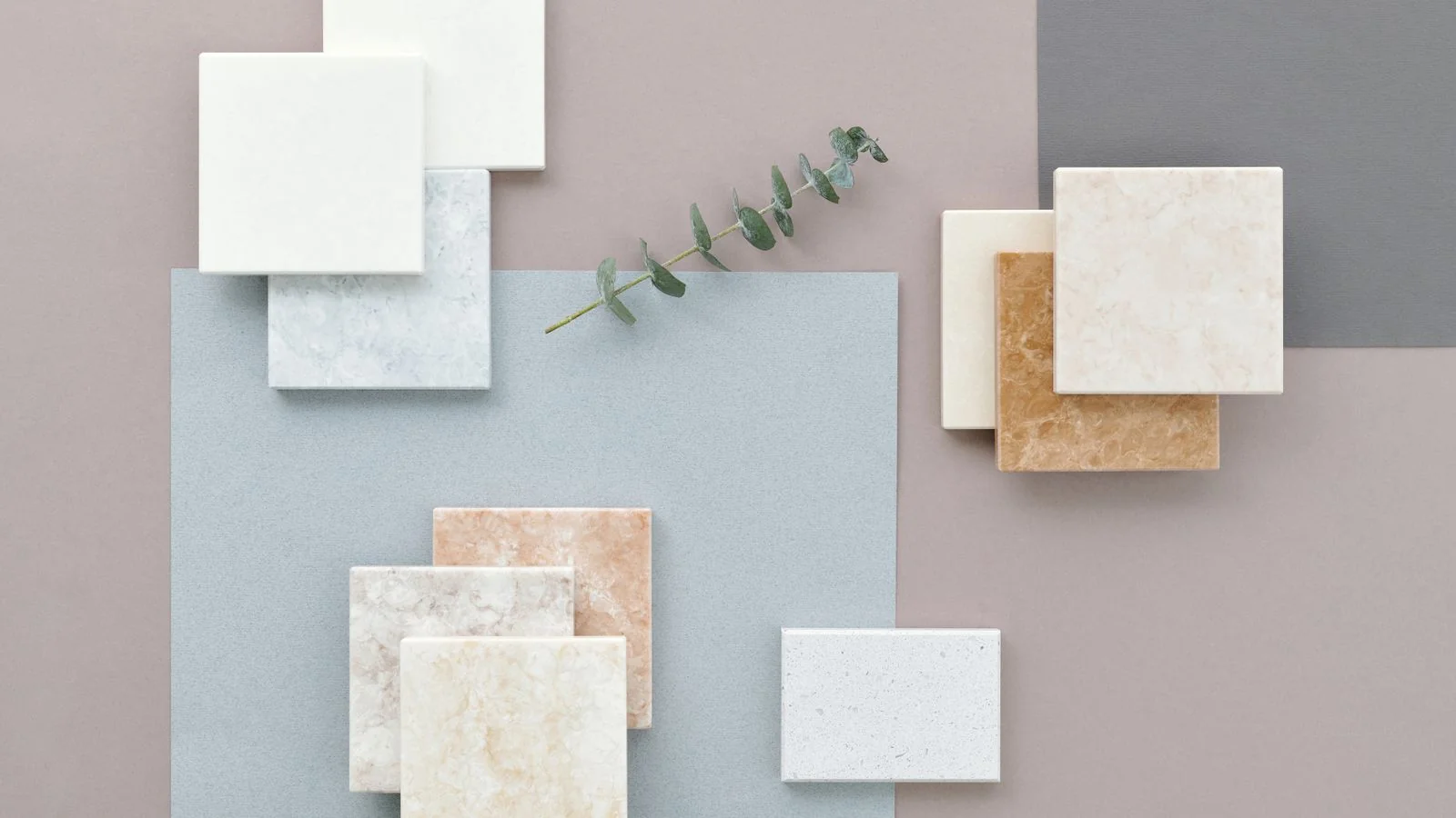 A flat lay of marble and ceramic tile samples like a showroom selection board.