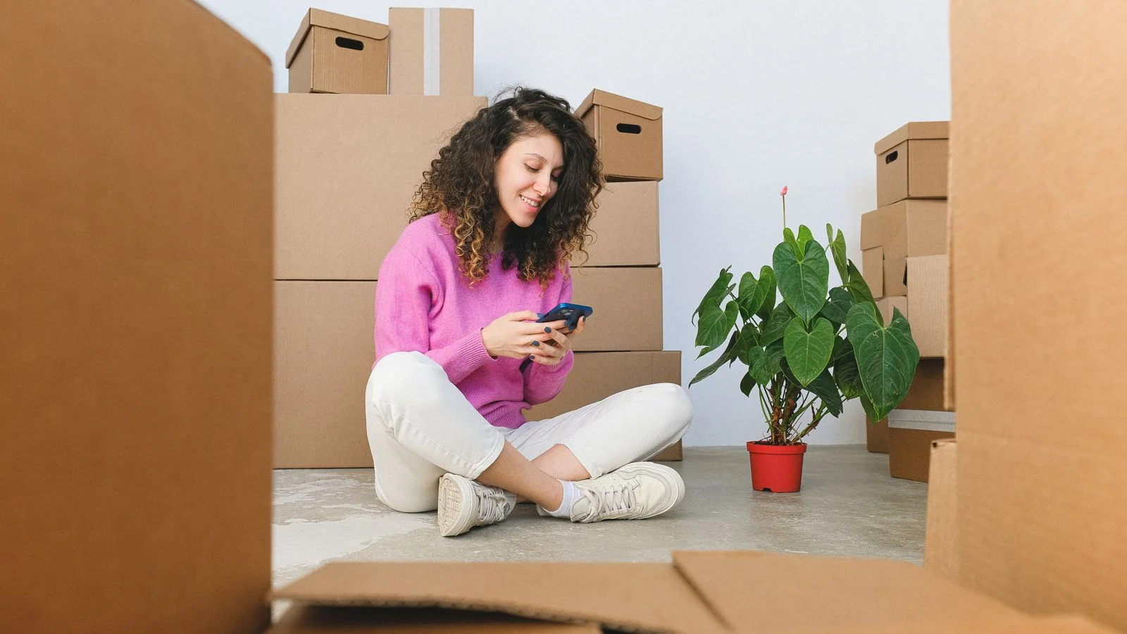 Homeowner searching for a repair answer on a phone at home