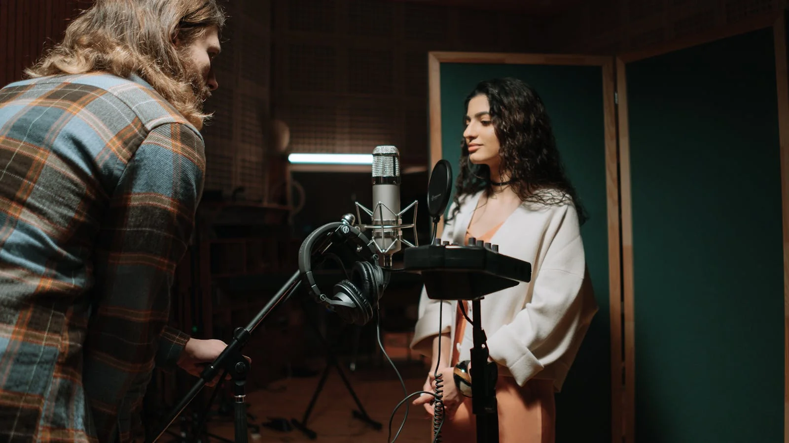 A vocalist recording in a professional studio, the artist behind the entity an AI has to get right