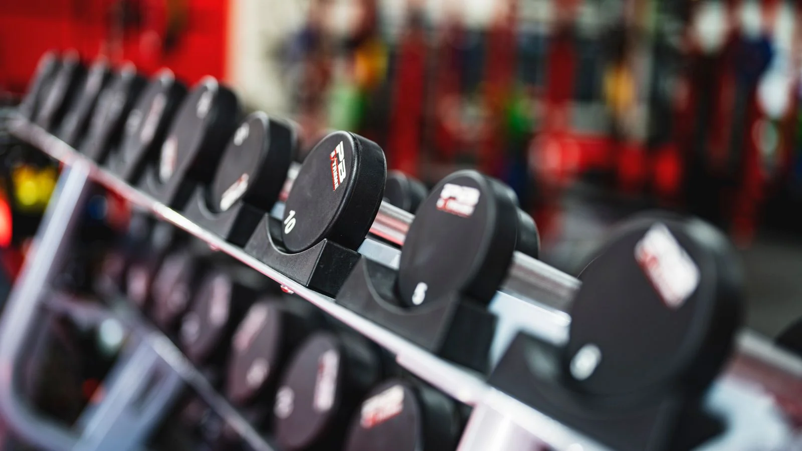 A rack of dumbbells on a quiet gym floor