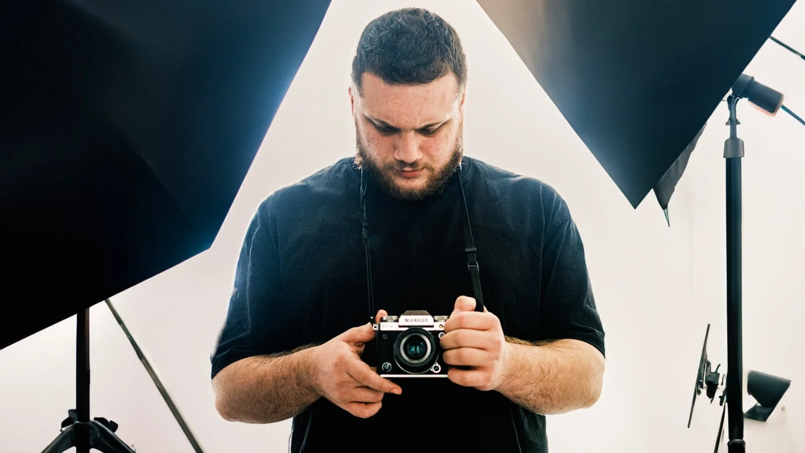 Photographer checking camera settings in studio between shots, the quiet moments testimonials capture