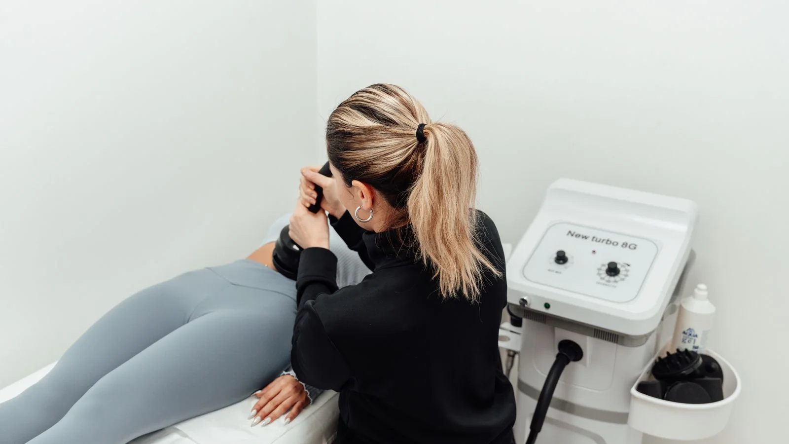 A physiotherapy clinic treatment room with a table and rehabilitation equipment ready for patients