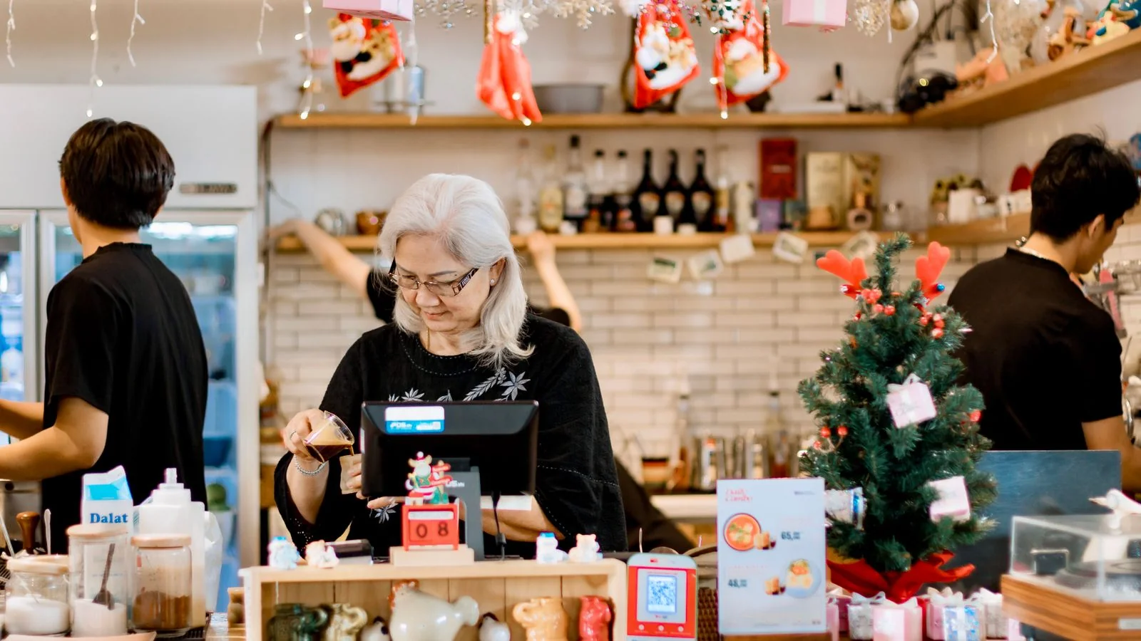A shop owner working the front counter, ready to greet a walk-in customer.