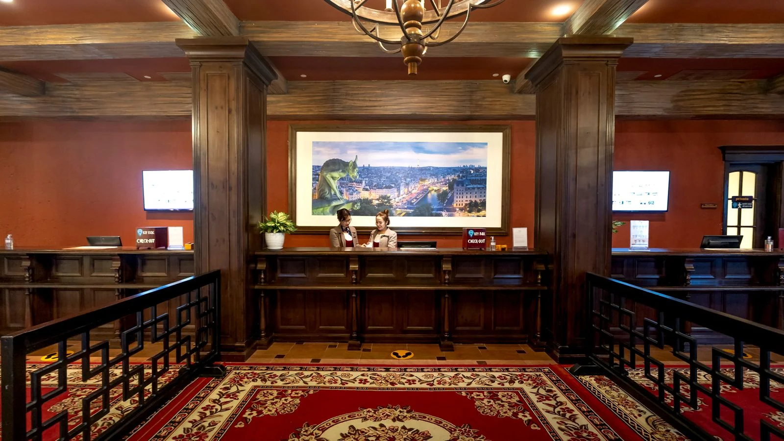 An elegant hotel reception area with a warm, welcoming front desk