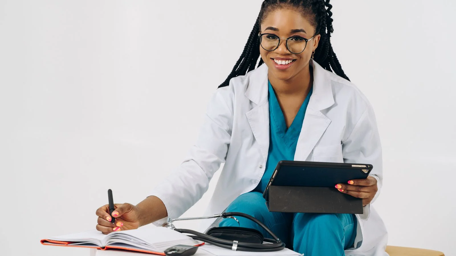 A clinician in scrubs taking notes on a tablet, representing the verified credentials AI engines look for