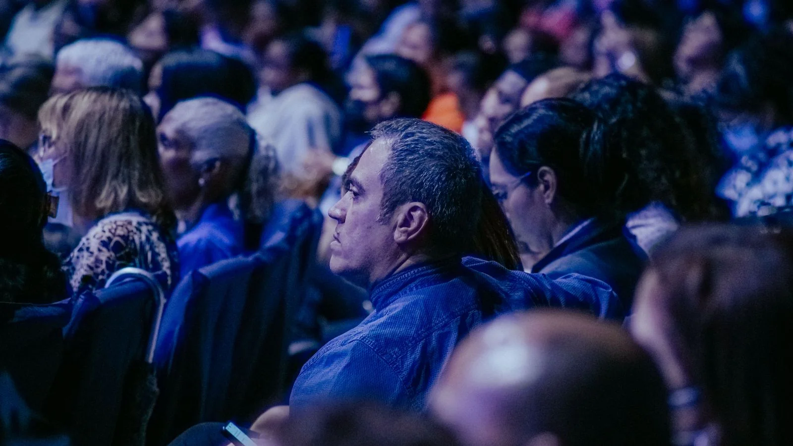 Large audience listening during an indoor business event