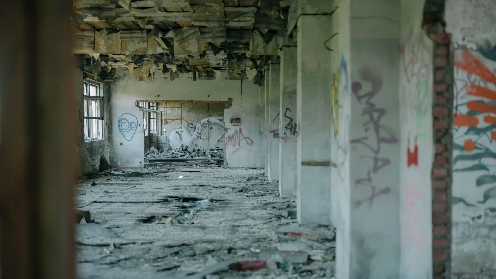 Abandoned building interior with peeling walls and graffiti, an image of digital decay
