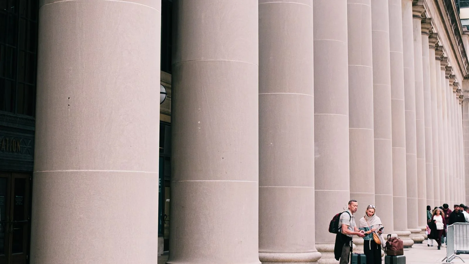 Grand stone columns of a civic building exterior, the architecture of the courts that oversee Chapter 11 cases