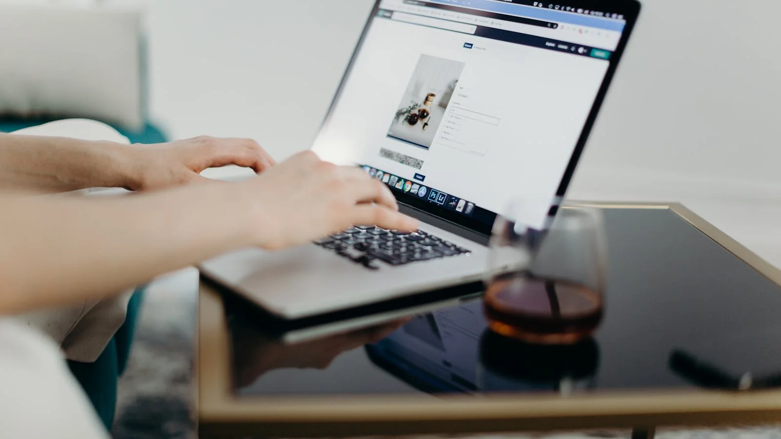 A person at a laptop drafting a careful reply to an online customer complaint.