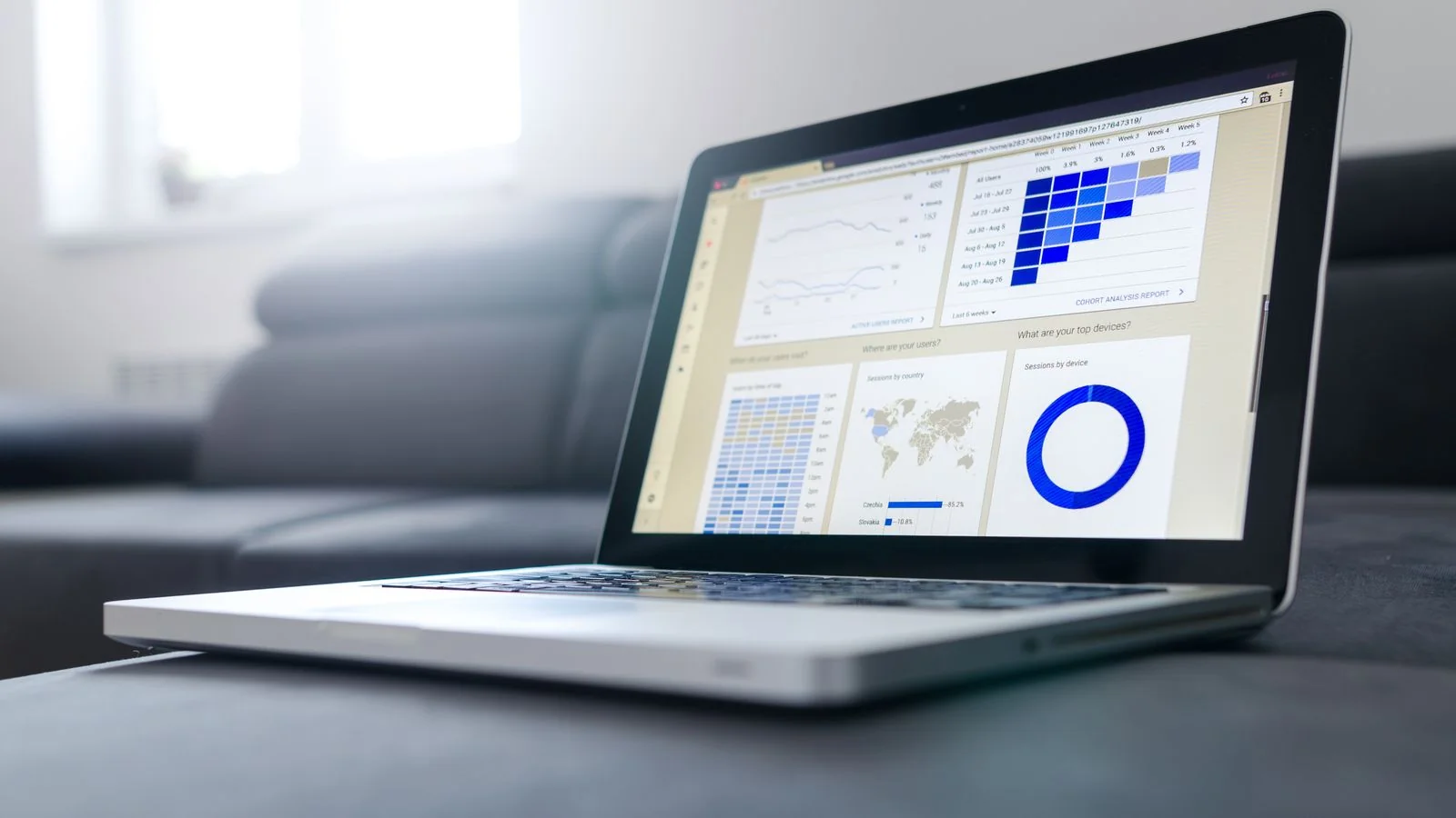 A marketer mapping the four jobs of AI visibility on a laptop with a dashboard open