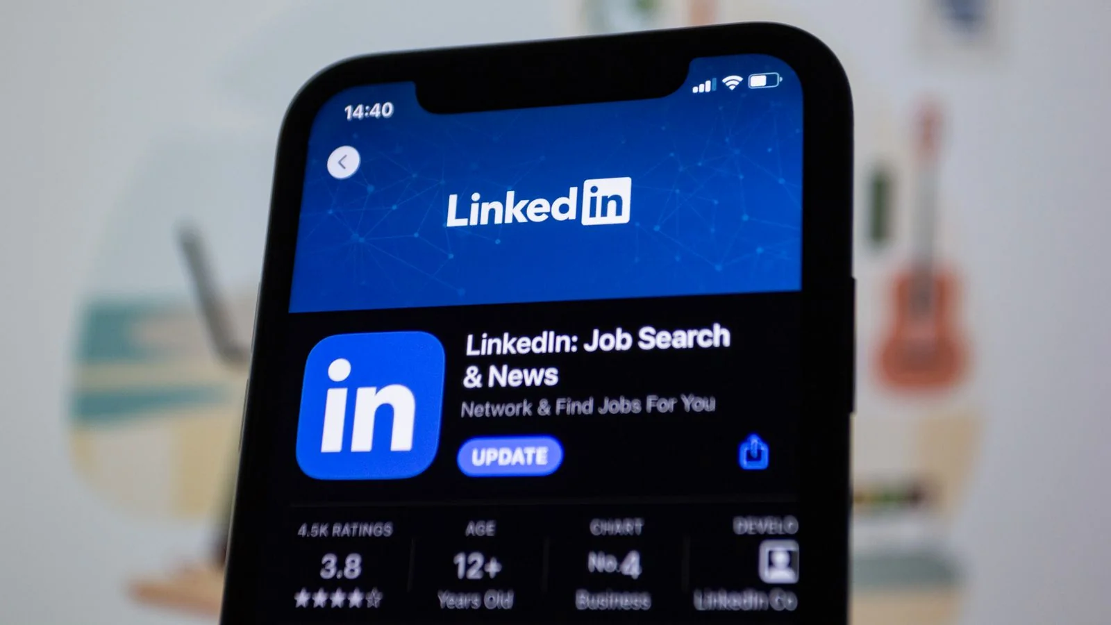 A professional reviewing their LinkedIn presence on a phone