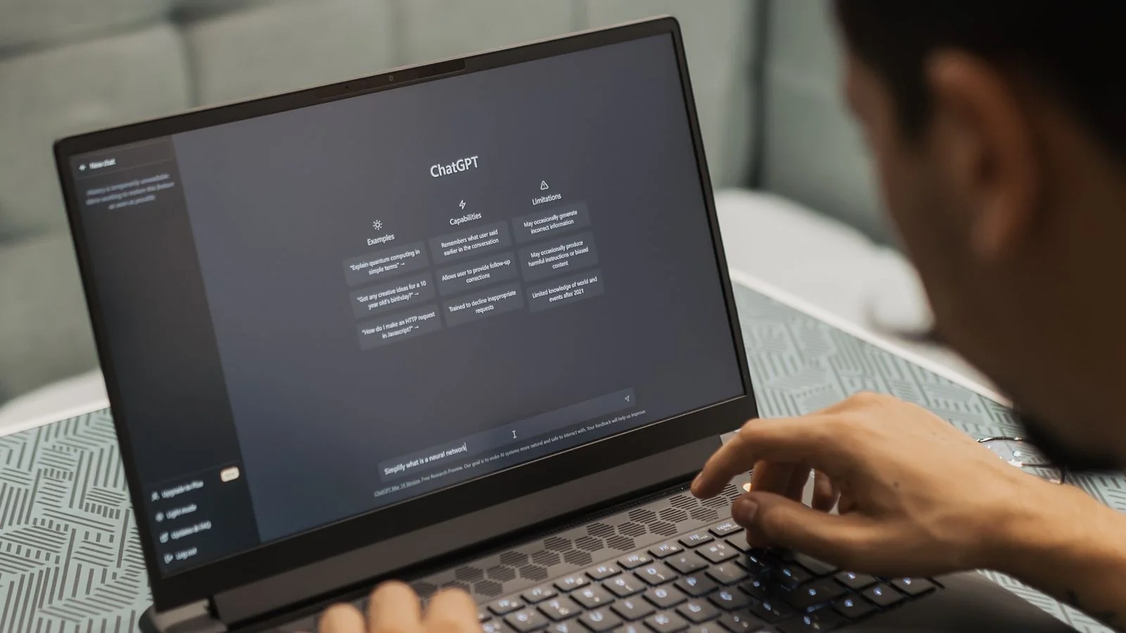 Hands typing on a laptop with an AI chat interface open, checking brand answers