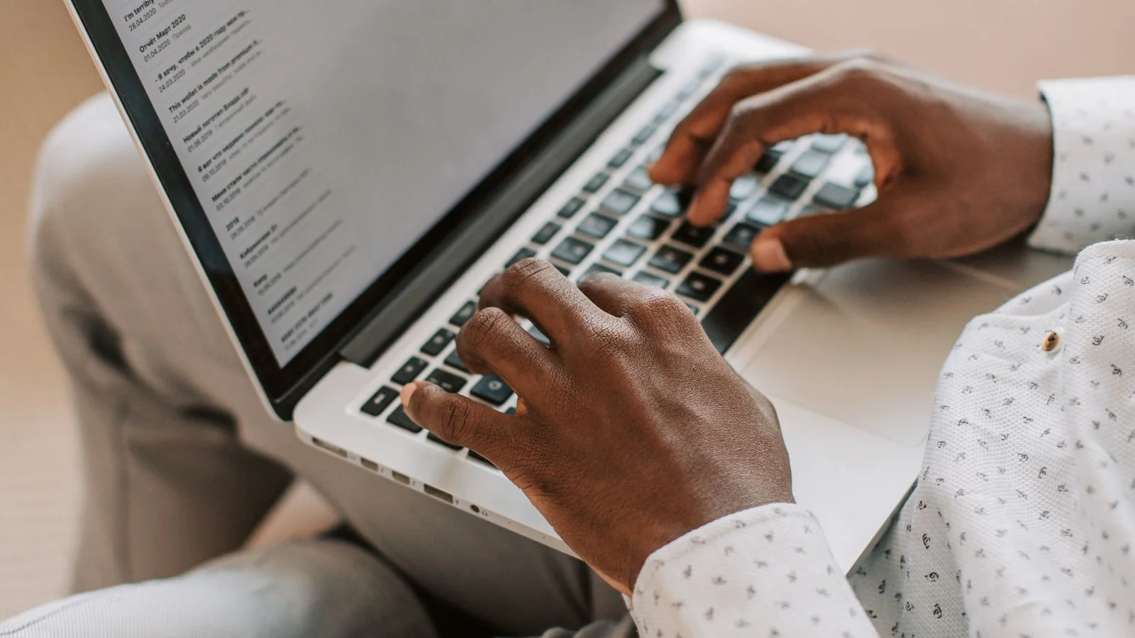 A person typing on a laptop at home, the quiet consistency both formats demand
