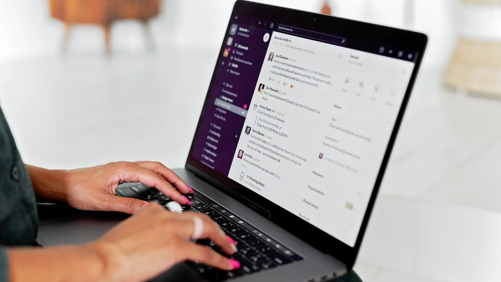 A person typing on a laptop with a messaging app open, the direct inbox relationship a newsletter owns
