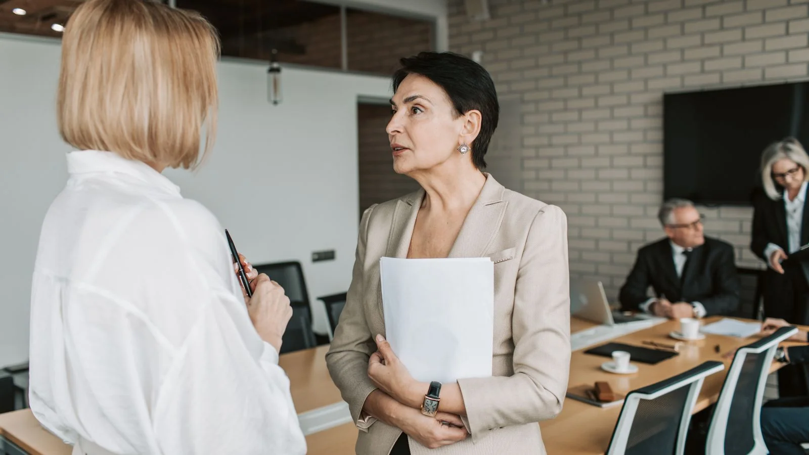 Two people in conversation, the kind of trusted recommendation an AI mention now imitates at scale