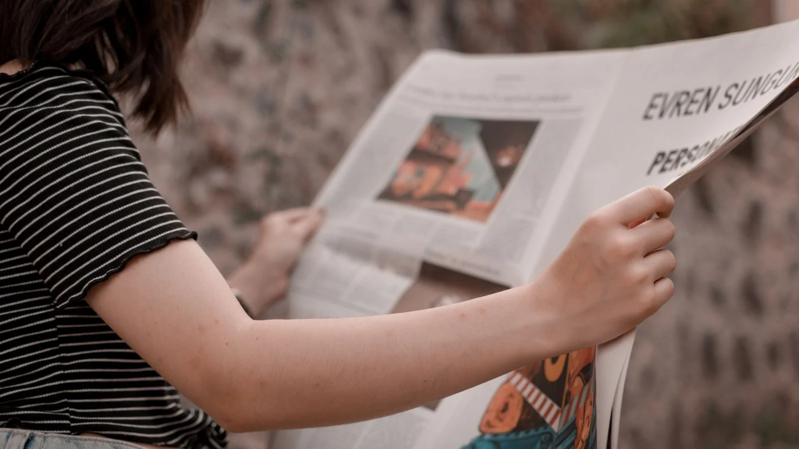 A newspaper being read, the credible published platform a byline article occupies
