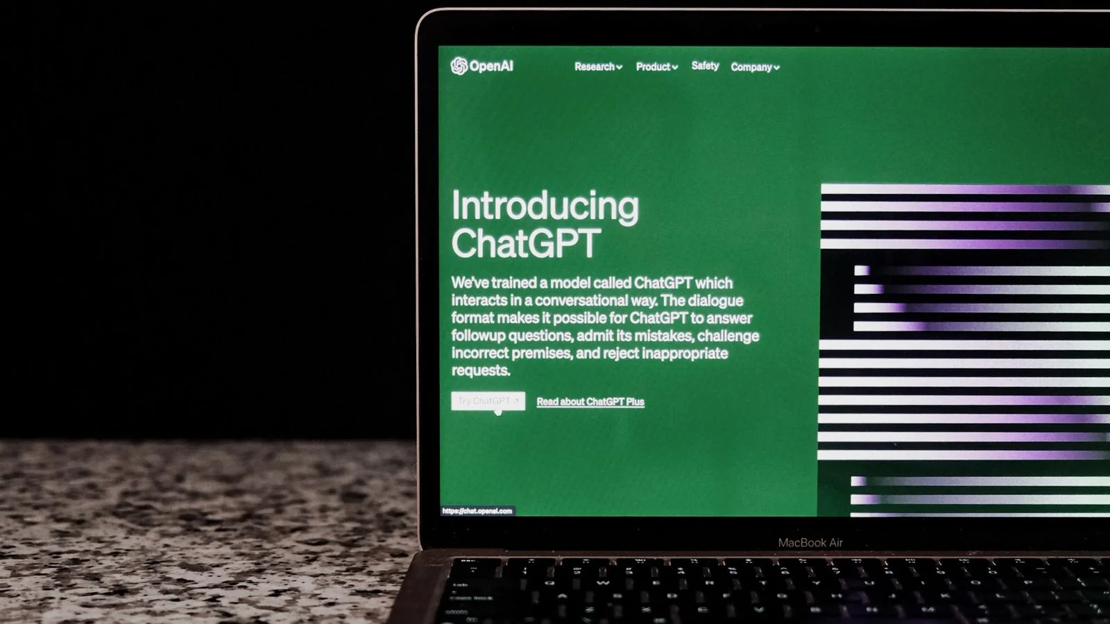 A laptop showing an AI chat interface on a marble surface, the answer shaped by whatever index sits behind it