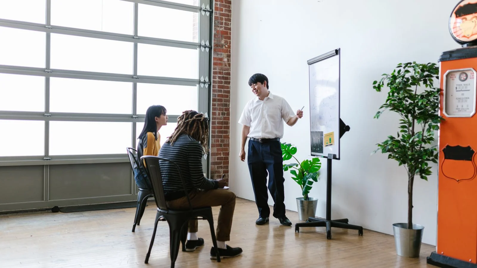A presenter working through options on a whiteboard, scoring vendors against one job at a time