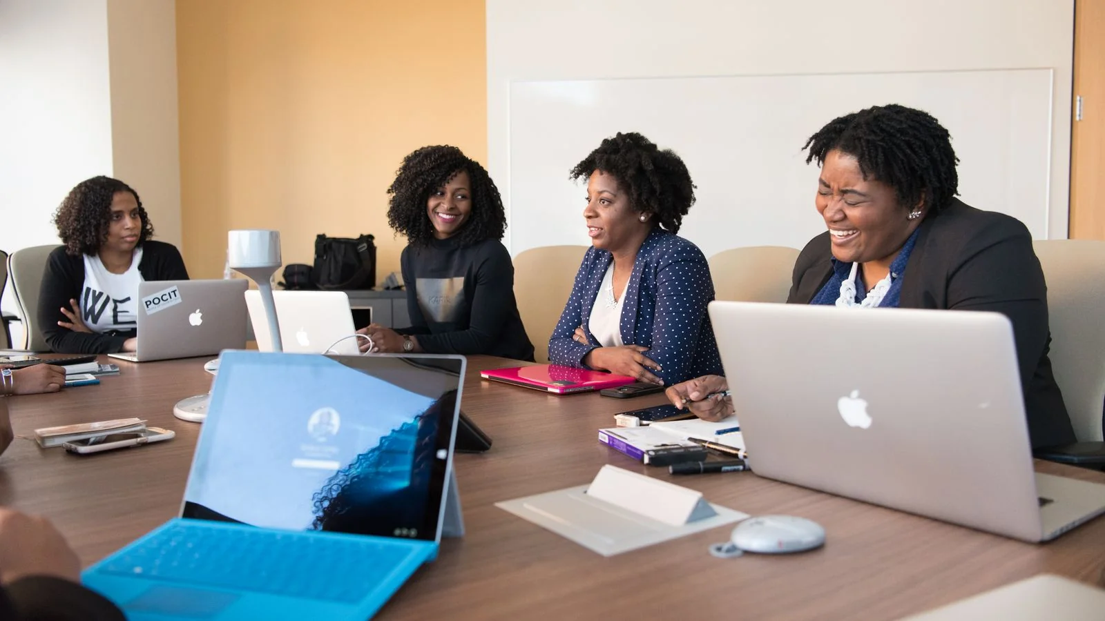 Enterprise team meeting around a conference table with laptops, the buyers this survey actually sampled