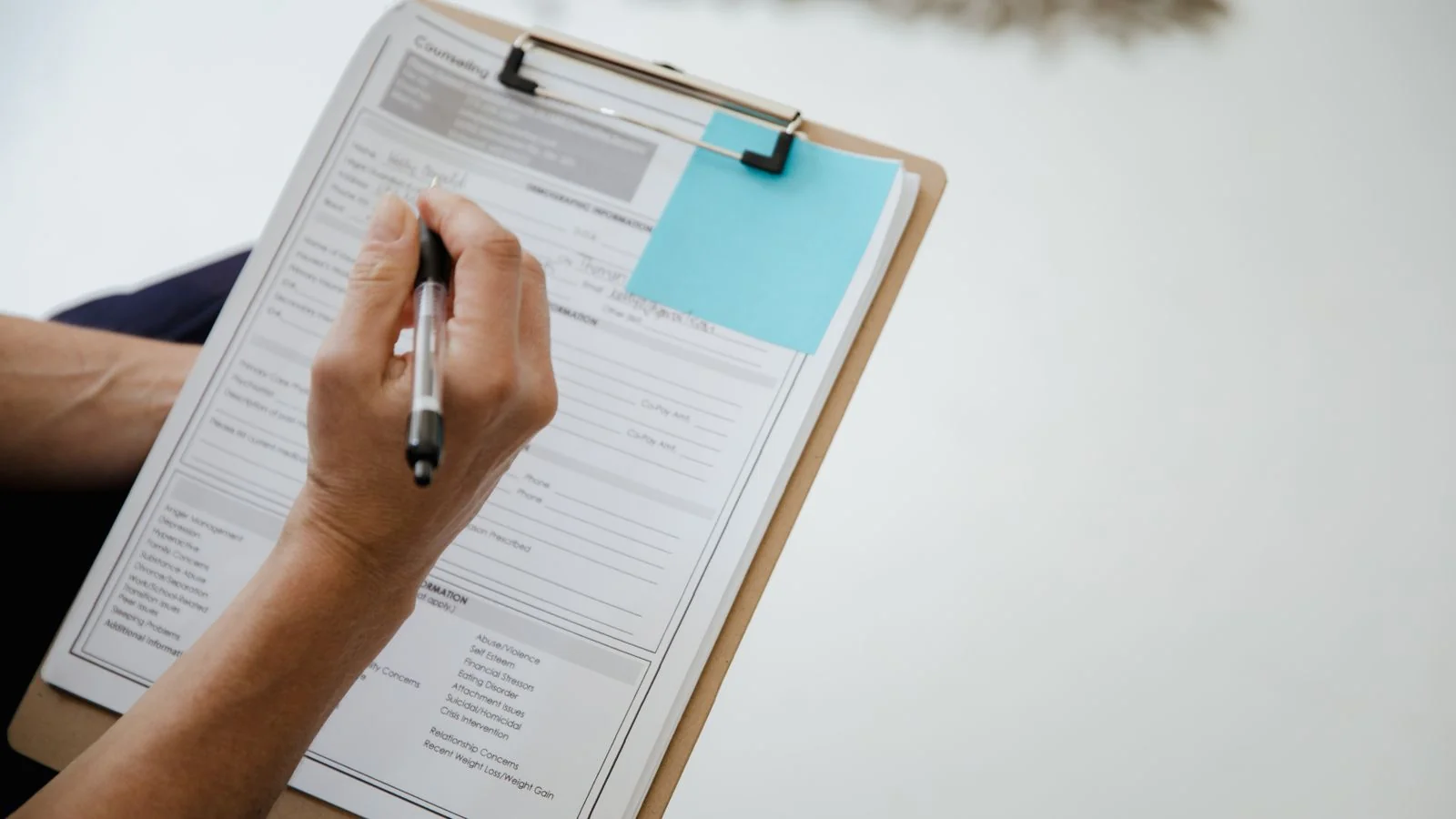 Filling in a form on a clipboard, the ask that keeps a review profile current