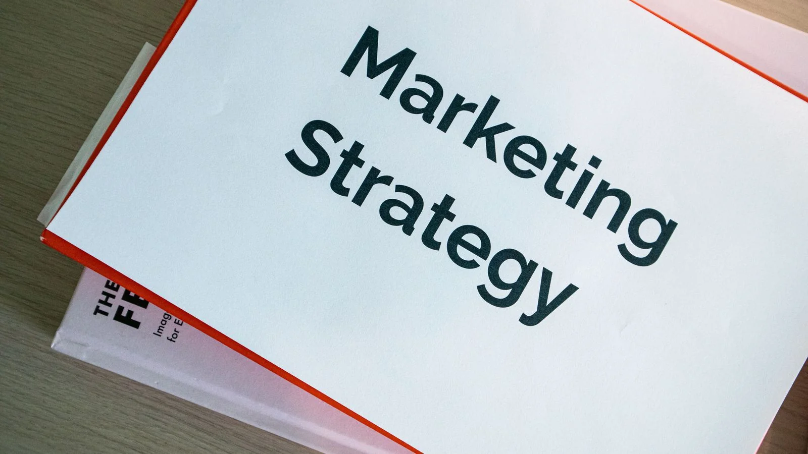 Marketing strategy documents spread on a desk, the page-by-page review an audit works through