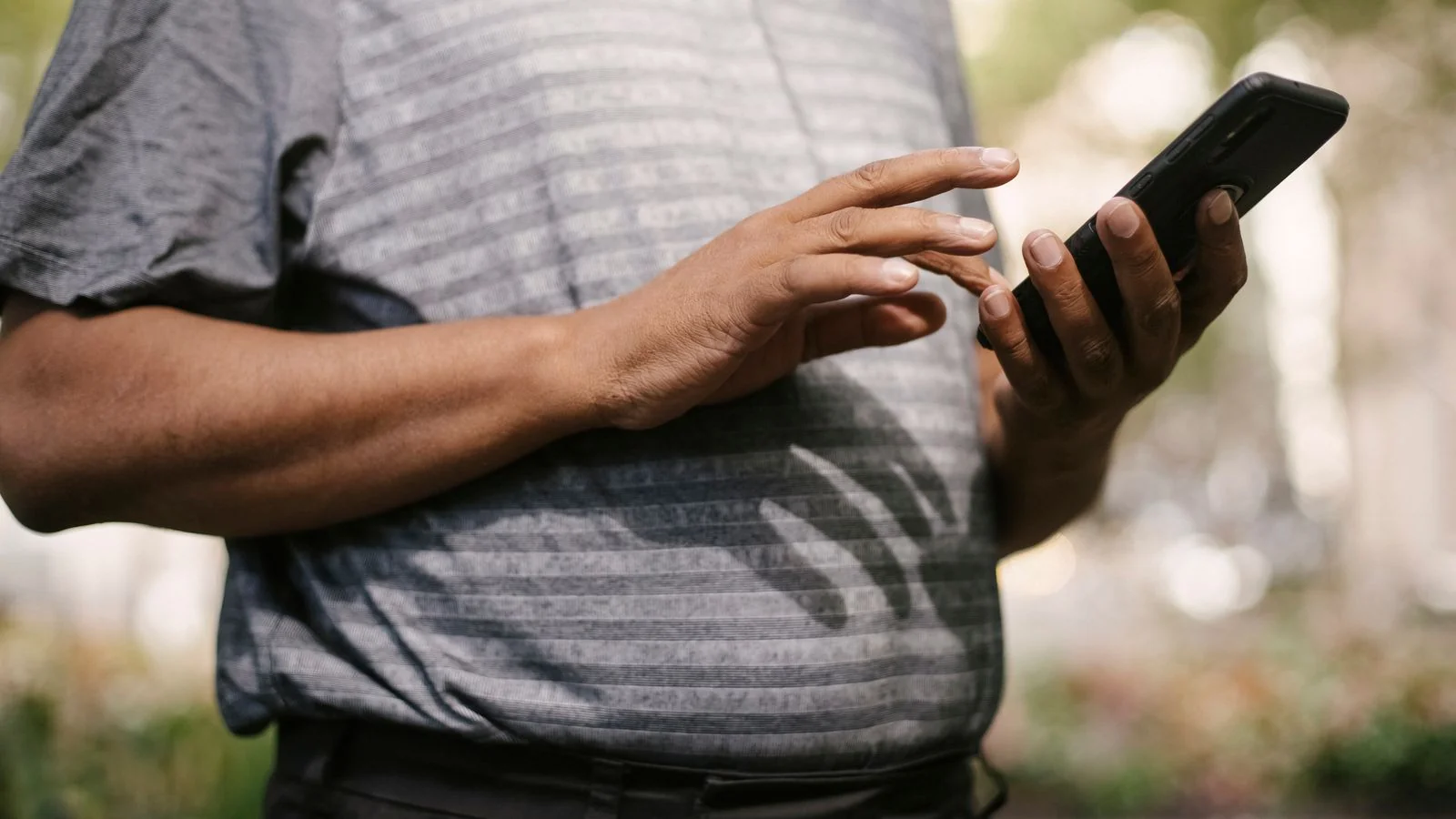 A person using a phone on a busy street, the scattered attention distribution has to reach across