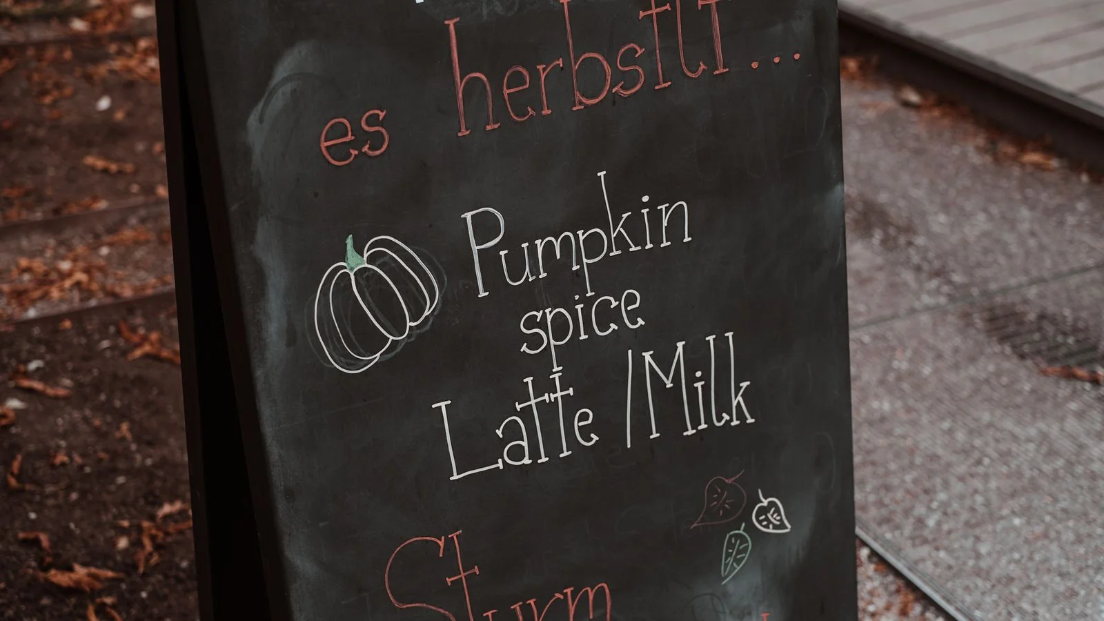 A chalkboard menu mounted on a cafe wall.