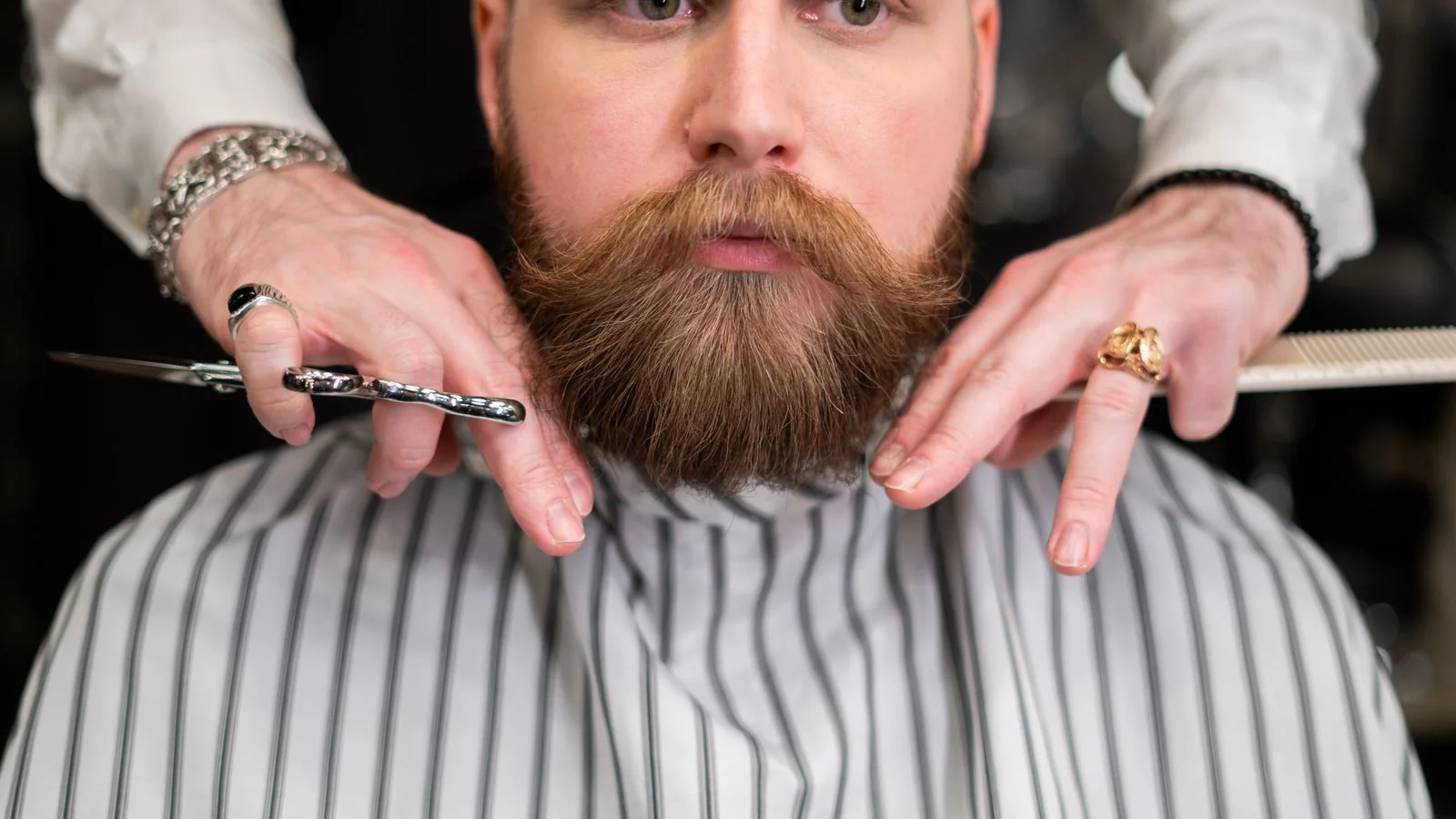 A bearded client having his line worked with precision, the correction step worth filming and explaining