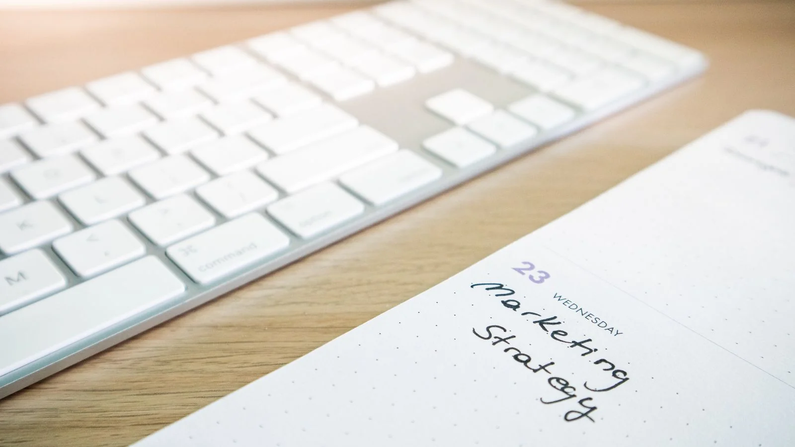A content calendar and keyboard on a desk, the planning behind a concrete company's blog.