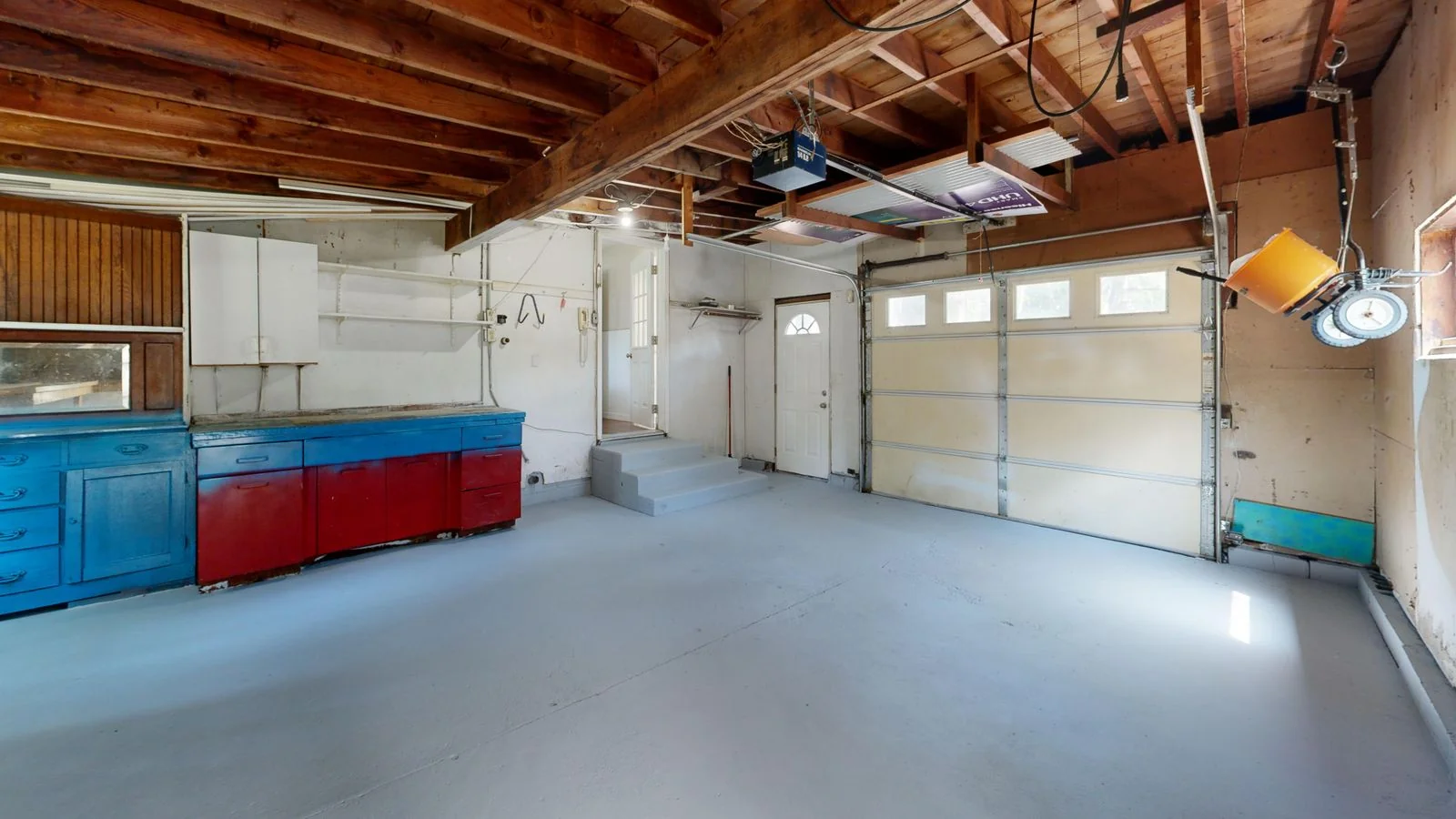 A clean, empty garage with open floor space after a full cleanout.