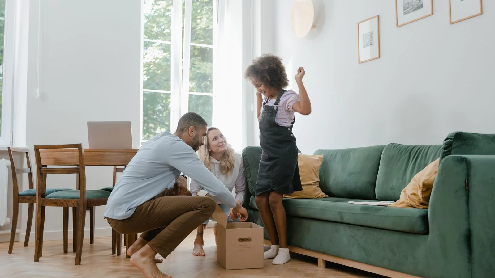A joyful family unpacking boxes together in their new home.
