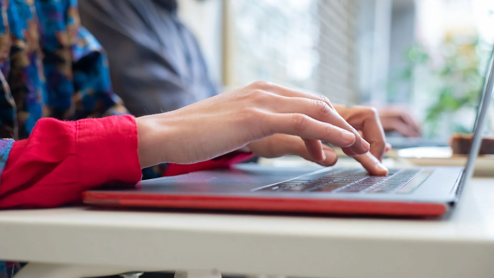 A person checking messages on a laptop.