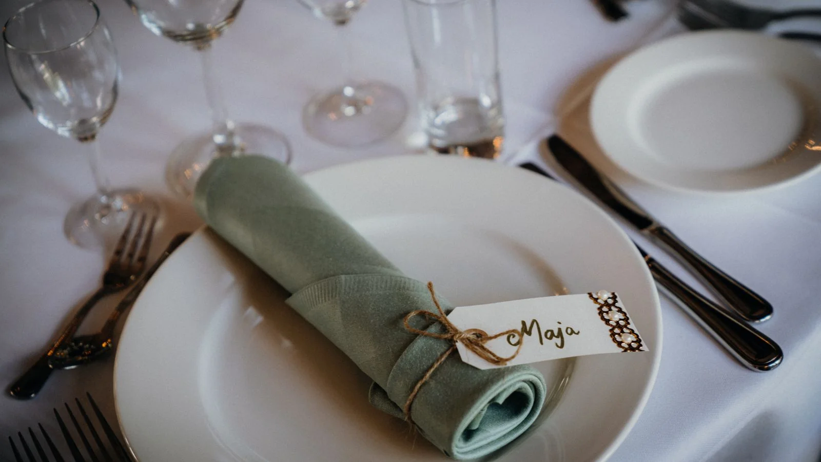 A wedding dining table with place settings and a name card, the detail level couples are actually trying to picture.