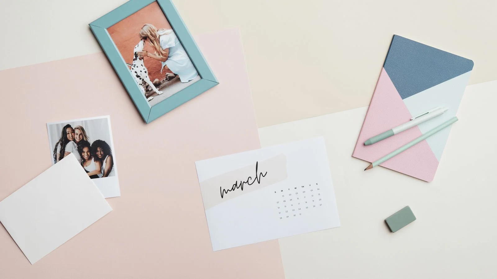A flat lay of a calendar and stationery on a desk, the deliberate structure behind a content plan that repeats on theme