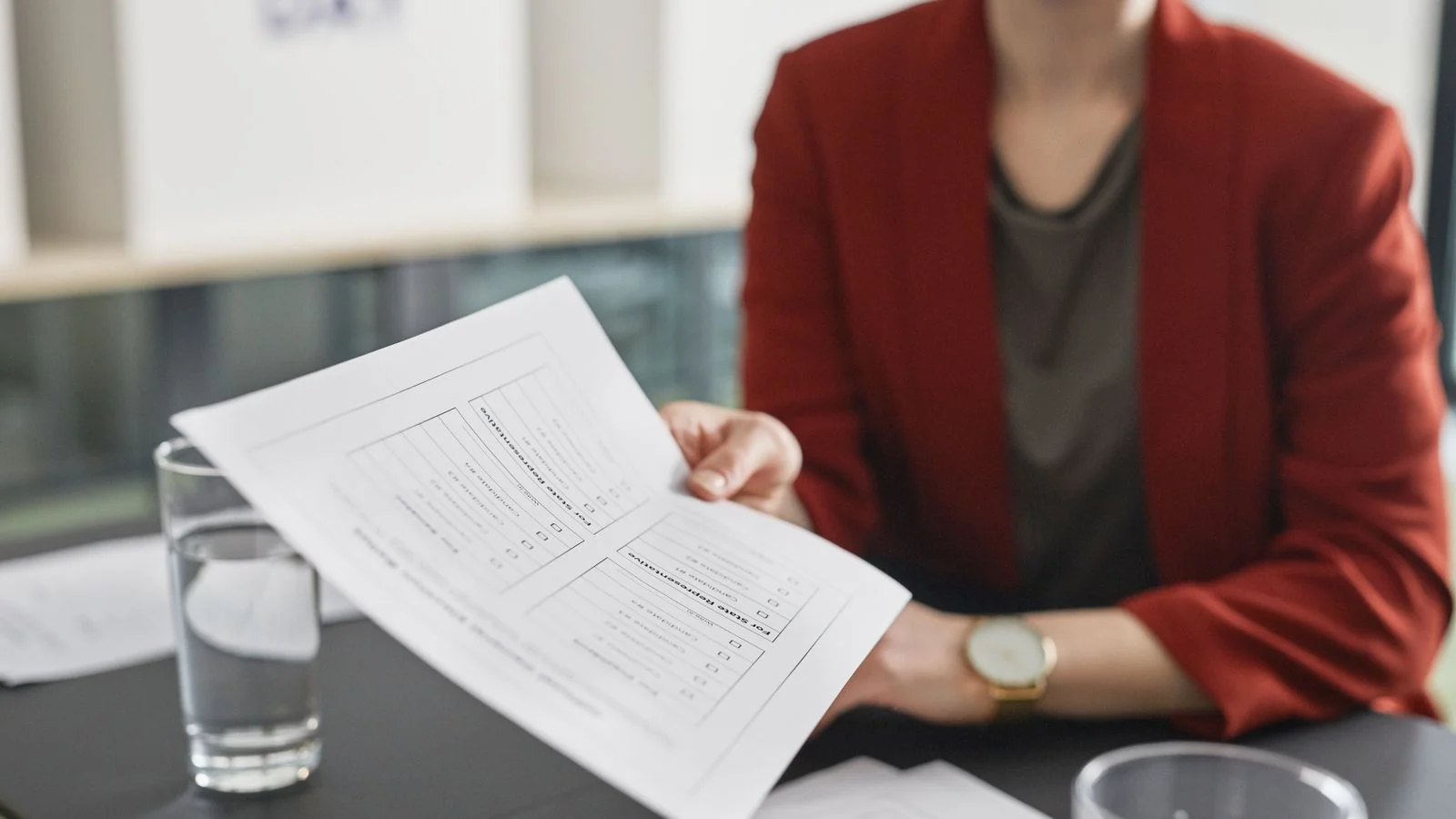 Close-up of a person handing over a business document during a meeting