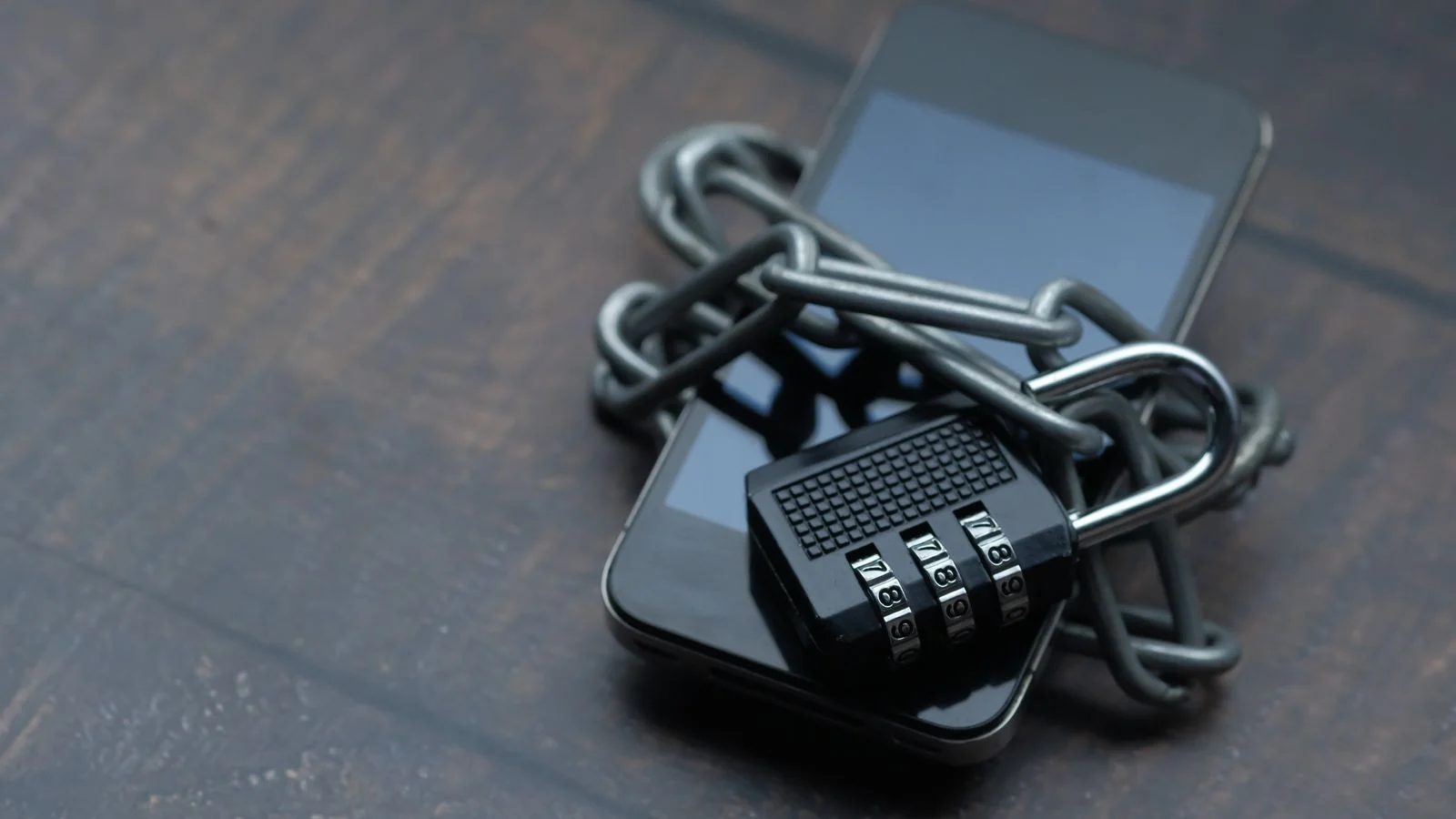 Smartphone wrapped in a chain and padlock, symbolizing locked-down personal data protection