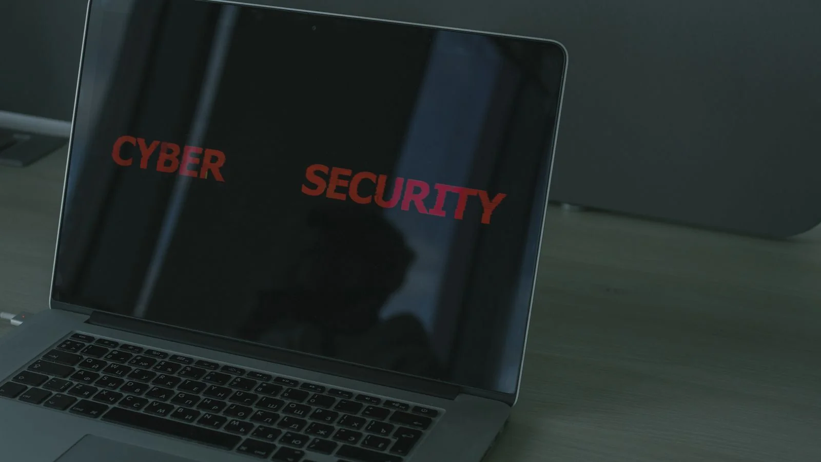 A laptop displaying cybersecurity text, evoking the passive data trail you leave online