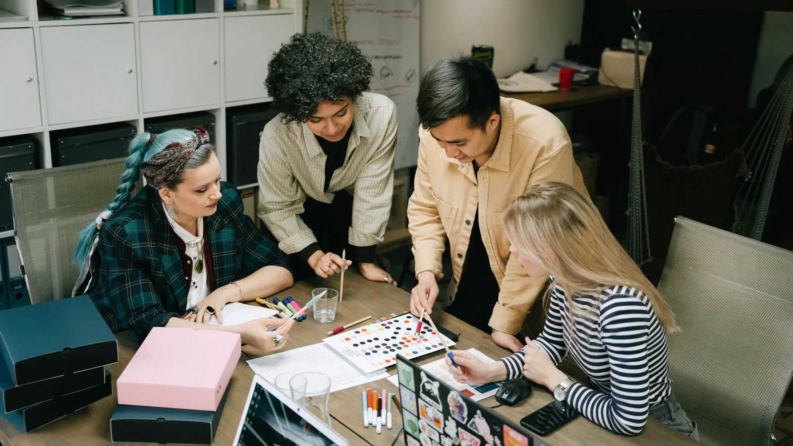 A diverse team collaborating on a project at a table in a modern office